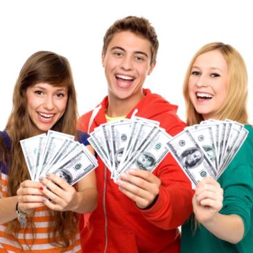 three teenagers holding up money and smiling