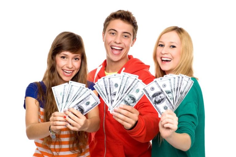 three teenagers holding up money and smiling