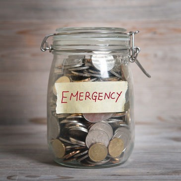 Coins in mason jar labeled emergency