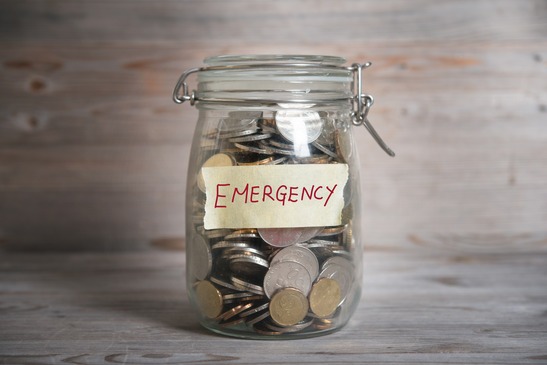 Coins in mason jar labeled emergency