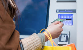 close up of person inserting card at an ATM machine